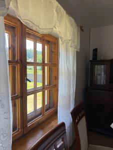 a room with a window and a wooden floor at Dom Letniskowy Sądecczyzna in Olszanka