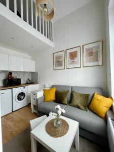 a living room with a couch and a table at Duplex cosy hyper centre in Amiens