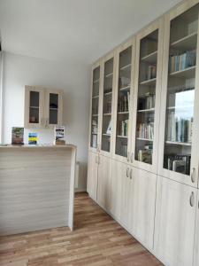 a room with white cabinets and a counter with books at Pokoje gościnne Jacek in Polańczyk