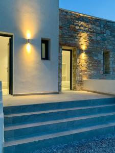 a set of stairs leading to a stone building at AiΘeria Suites Ios - Room Avra in Ios Chora +4 photos