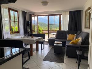 a living room with a couch and a table at Alpenjuwel in Krün