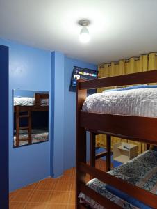 a bedroom with two bunk beds and a mirror at La Casa del NONO in Cajamarca