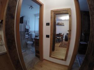 a bathroom with a large mirror and a kitchen at Appartamento Pré-Saint-Didier, terme in Pré-Saint-Didier +19 photos