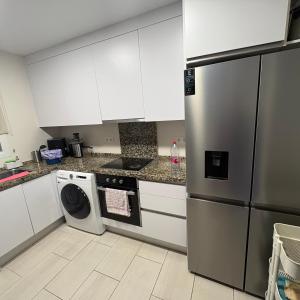 a kitchen with a refrigerator and a dishwasher at Marbella urbanización privada in Marbella