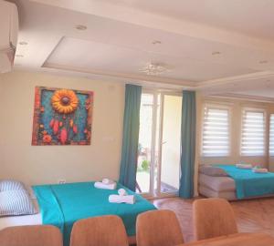 a living room with two beds and a painting on the wall at Villa ARIA in Trpejca