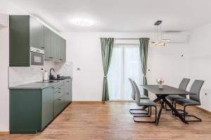 a kitchen with a table and a table and chairs at Apartmaji Gašperčič, NEJC in Bovec