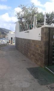 a brick retaining wall with a stone wall at Il Capriccio Guesthouse in Ponza