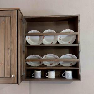 a cabinet filled with cups and saucers at Oneiropetra 3 in Mouzaki +14 photos
