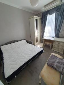 a bedroom with a large bed and a desk at Ziedulejas in Beika