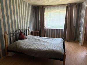 a bedroom with a bed and a window at Cozy Apt in Haanja in Haanja