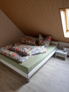 a bed with pillows on it in a room at Ferienwohnung Schlesinger in Hohnstein