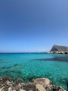 a view of the ocean with rocks in the foreground at Casa Vacanze Marinella Beach in San Vito lo Capo