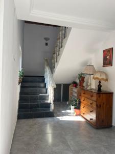 a hallway with stairs and a stair case at Casa Dina in Băile Herculane