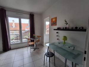 a living room with a table and a window at Metz Port Saint Marcel in Metz