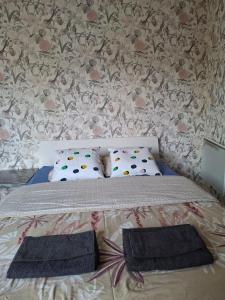 a bedroom with a bed with two pillows on it at Metz Port Saint Marcel in Metz
