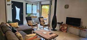 a living room with a couch and a table at ANAHATA Appartement-Maison in Saint Paul de Vence