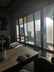 a living room with a table and some windows at Hotel Hobby in Hunedoara