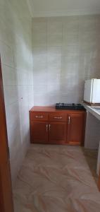 a kitchen with wooden cabinets and a counter top at Hopeland Villas in Msaranga