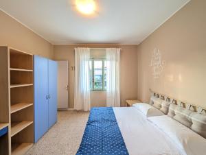 a bedroom with a large bed with a blue rug at Locanda San Marco in Caorle