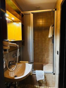 łazienka z umywalką i prysznicem w obiekcie See-Hotel Post am Attersee w mieście Weissenbach am Attersee