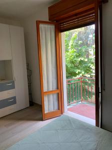 a room with a door open to a balcony at A Casa di Vanna in Montese
