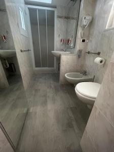 a bathroom with a toilet and a sink at La Nicchia nel Carugio in Portovenere