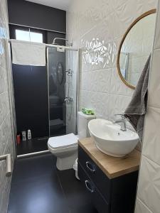 a bathroom with a sink and a toilet and a shower at Yenikent's Diamond in Nicosia +41 photos