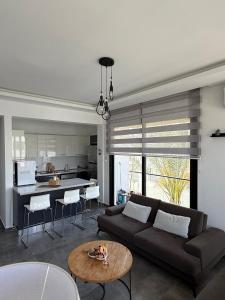 a living room with a couch and a table at Yenikent's Diamond in Nicosia