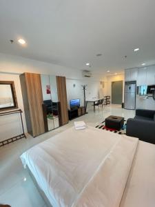 a living room with a large white bed and a kitchen at Mercu Summer Suites Apartment With Balcony in Kuala Lumpur +78 photos