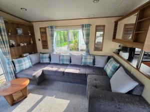 a living room with a couch and a window at Duck Creek at Beacon Fell View in Longridge