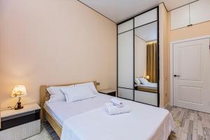 a small bedroom with two beds and a mirror at Шикарная Двушка в самом центре Алматы #12 in Almaty
