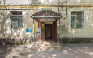 an entrance to a building with an arch over a door at Шикарная Двушка в самом центре Алматы #12 in Almaty