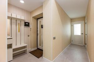 a room with a hallway with a door and a window at Шикарная Двушка в самом центре Алматы #12 in Almaty +17 photos