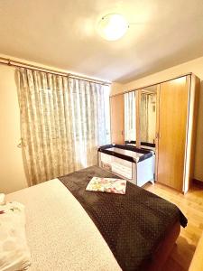 a bedroom with a bed and a dresser and a window at Beach Bliss Apartment in Pržno