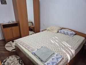 a bedroom with a bed with a blanket on it at Tulcea Soft Apartment in Tulcea