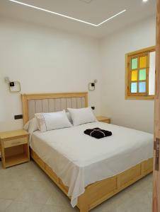 a bedroom with a large bed with white sheets at Stay with dkouk in Akchour