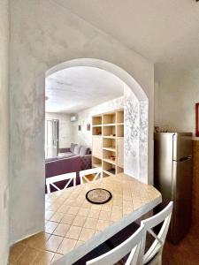 a kitchen with a table and a refrigerator at Beach Bliss Apartment in Pržno