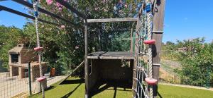 a swing set in the middle of a garden at Villa Antonia in Gibraleón