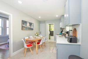 a kitchen and dining room with a table and chairs at Spacious 3BR Near NYC with Workspace in Newark