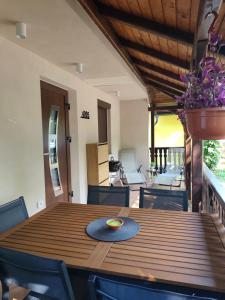 a dining room with a wooden table and chairs at Hiška 4005 - Terme Čatež in Brežice