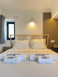a bedroom with a large bed with two pillows on it at Casa de Chanquete in Viana do Castelo