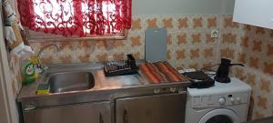 a kitchen counter with a sink and a stove at Giannis Valeria in Rhodes Town +13 photos