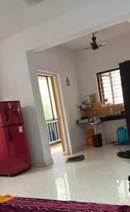 a kitchen with a red refrigerator in a room at Palms Cosy affordable homely flat in Arpora
