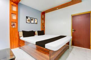a bedroom with a bed and a wooden door at OYO Annapurna Restaurant & Hotel in Patna +23 photos
