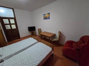 a room with two beds and a table and a chair at Villa Relax Apartments in Budva