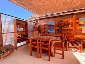 a dining room with a wooden table and chairs at Hostal Hara in San Pedro de Atacama