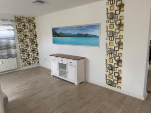 a room with a table and a painting on the wall at Ferienwohnung in Glücksburg