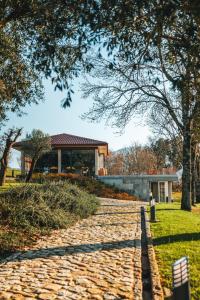 a stone walkway leading to a building at Quinta da Torre - Anselmo Mendes in Cortinhas +22 photos