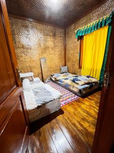 a room with two beds and a window at Zann Villa Ciwidey in Panundaan