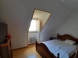 a bedroom with a bed and a window and a mirror at Chambres de charme en Normandie in Hauterive
